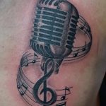 Amazing-Grey-Ink-Mic-And-Music-Notes-Tattoo-On-Chest